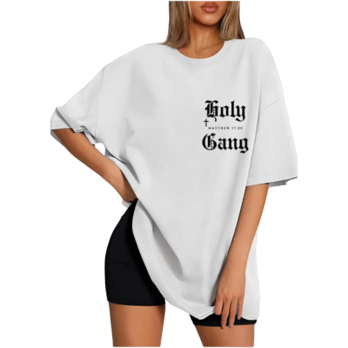 Front of female model wearing a white oversized Holy Gang t-shirt with black gothic logo, cross and Matthew 17:20 verse. 